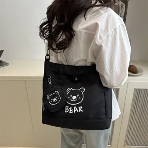 Detailed view of the cute bear print canvas shoulder tote bag in black daily style.