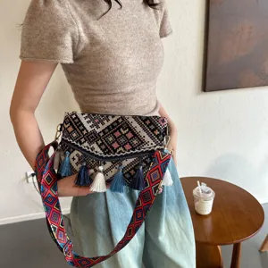 Ethnic style woven crossbody bag with colorful geometric strap and tassel charms for women