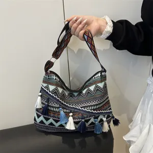 Boho ethnic style canvas shoulder bag with geometric stripes and colorful tassels, casual.