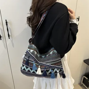Ethnic style tassel shoulder bag detail view, casual geometric striped patterned handbag.