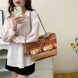 Boho woven tote bag for women, large capacity shoulder bag with colorful straps and tassels.