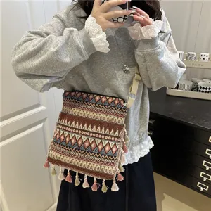 Ethnic retro vintage style shoulder crossbody bag with tassel bohemian woven design for women.