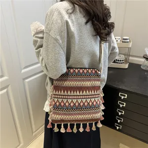 Ethnic style woven crossbody bag for women with chic tassel and retro geometric patterns.