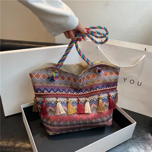 Boho woven tote bag with colorful handles and tassels for women's daily fashion style.