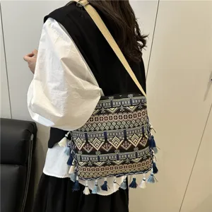 Ethnic style cross-body shoulder bag with geometric woven patterns and cute tassels for women.