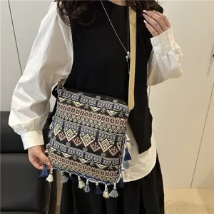 Detailed view of ethnic style retro crossbody bag featuring geometric patterns and tassels.