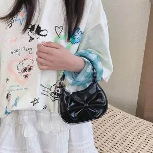 Kids mini black patent leather handbag with cute bow, trendy fashion shoulder bag for girls.