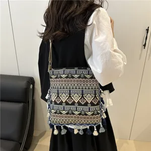 Women ethnic style vintage crossbody bag with tassels, simple neo-Chinese woven shoulder handbag.