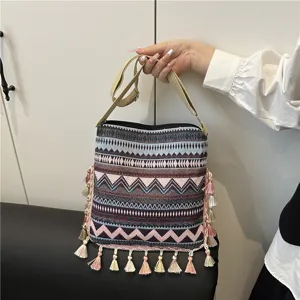 Ethnic style tassel shoulder bag, featuring geometric woven patterns and bohemian design details.