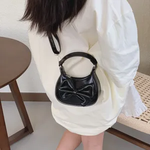 Kids black mini handbag detail showing cute bow design, elegant style for daily wear and parties.