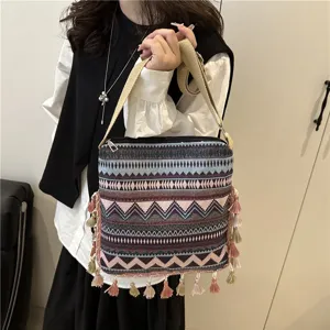 Detailed view of the ethnic style tassel shoulder bag with retro geometric pattern and straps.