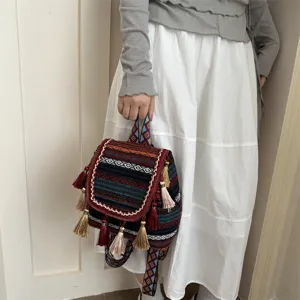 Ethnic style boho geometric print backpack detail featuring playful tassels and chic straps.