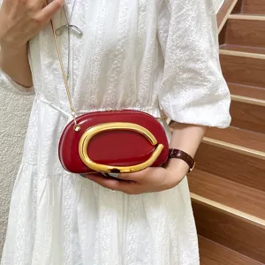 Chic red mini crossbody bag with bold gold C metal hardware and stylish chain strap.