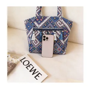 Ethnic style tassel tote bag detailed view, large capacity vintage shoulder handbag for women.