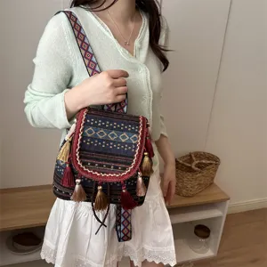 Ethnic boho backpack detail view showing geometric woven strap and tassel decoration.
