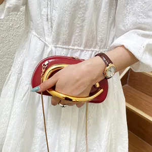Chic red mini crossbody bag with luxury gold handle and chain strap for women fashion style.