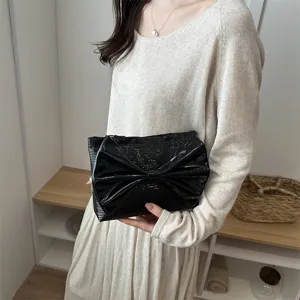 Black patent leather bow clutch bag for women, stylish large capacity evening handbag.