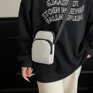 Close-up detail of lightweight grid crossbody phone bag, casual daily accessory.