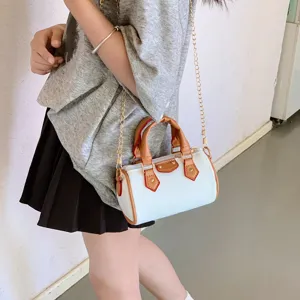 Detail view of kids mini pillow bag with chain strap, white and brown stylish accessory.