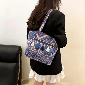 Ethnic style tassel tote bag detail view, large capacity shoulder bag for women daily commute.
