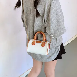 Kids mini barrel shoulder bag with chic chain strap, trendy faux leather crossbody handbag.