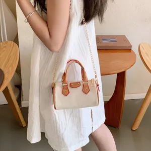 Chic mini canvas shoulder crossbody bag featuring a golden chain strap and brown leather trim.