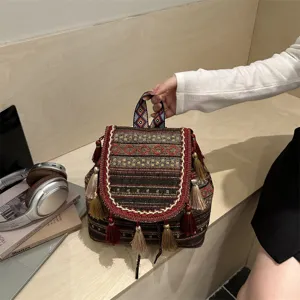 Ethnic style woven backpack detail featuring colorful geometric patterns and hanging tassels.