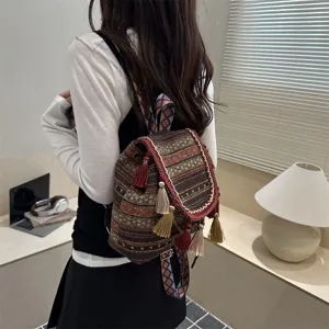 Ethnic woven backpack with tassels and geometric patterns for stylish daily travel use.