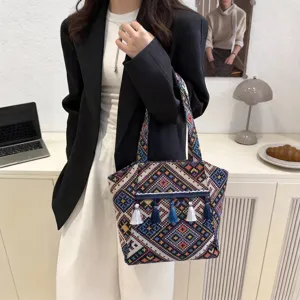 Detailed view of the ethnic woven tote bag with colorful tassels, large capacity commuter bag.