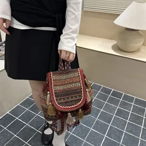 Ethnic style woven backpack detail, featuring geometric diamond print and tassel design.