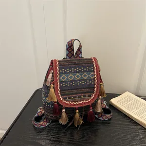 Ethnic style woven backpack detail, featuring colorful geometric rhombus patterns and tassels.