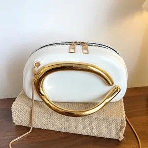 Stylish white crossbody bag with unique gold metal handle and chain strap for women daily.