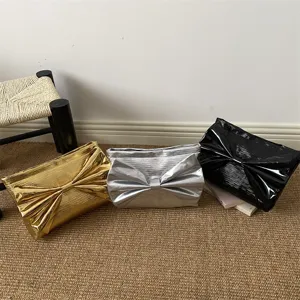 Elegant metallic finish clutch bag with large bow, chic evening purse for women stylish.