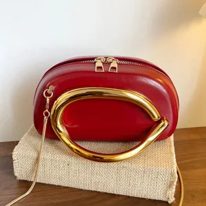 Stylish red women shoulder crossbody bag with unique gold ring handle and chain strap.