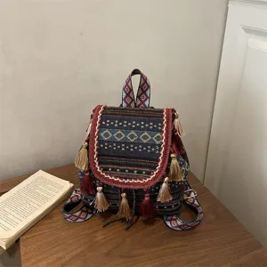 Ethnic style woven backpack with geometric rhombus patterns, tassels and comfortable straps.