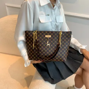 Chic brown monogram tote bag for women with gold chains and deer pendant for daily work.