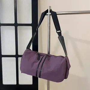 Purple large capacity shoulder crossbody travel bag, detailed view showing zipper and strap.