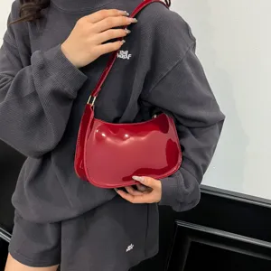 Red patent leather shoulder bag for women, chic underarm hobo bag, retro minimalist handbag.