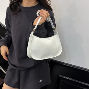 Minimalist white shoulder hobo bag for women, elegant crescent design with metal hardware.
