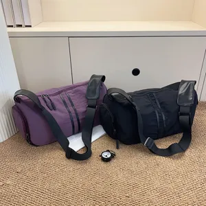 Large capacity casual shoulder bag and travel duffel with wide strap and dual stripe design.