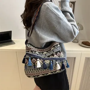 Ethnic style tassel shoulder bag featuring geometric stripes and casual design details.