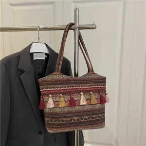 Ethnic woven colorful tote bag with tassels, stylish large capacity shoulder bag detail view.