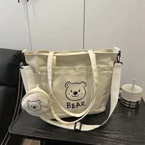 Canvas tote bag detail view, casual minimalist shoulder bag with bear print and purse.