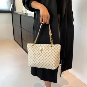 Elegant chic beige tote bag with classic monogram print, gold chain straps, ideal for commuting.