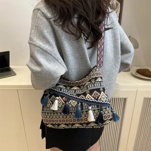 Detailed view of the ethnic style canvas shoulder bag with colorful tassels and geometric patterns.