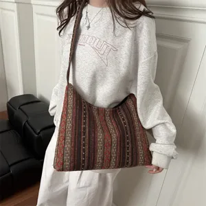 Boho style woven shoulder bag detail showcasing retro geometric striped fabric and texture.