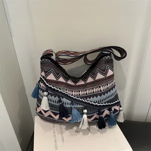 Bohemian ethnic woven shoulder bag detail showcasing colorful geometric patterns and tassels.