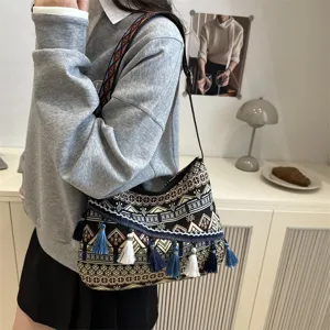 Ethnic style women shoulder bag with geometric patterns, chic tassels and wide strap.