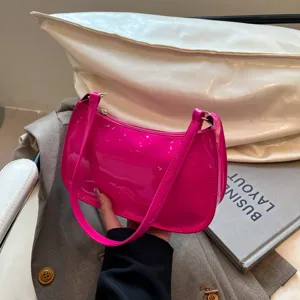 Hot pink patent leather shoulder bag for women, stylish underarm handbag for daily commute.