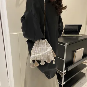 Woven tassel bucket bag for women, ethnic style shoulder cross body bag with drawstring.